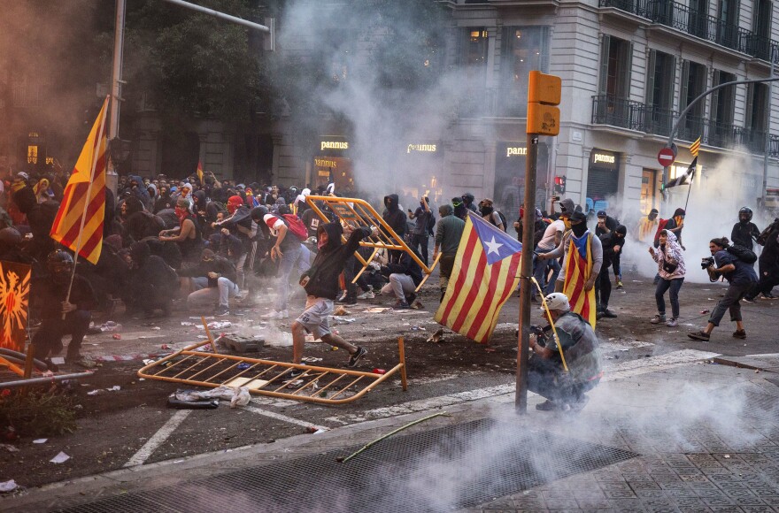 Demonstrators clash with police in Barcelona, Spain, on Friday. Catalonia's capital has been gripped by protests over the conviction of a dozen Catalan independence leaders. Five marches with tens of thousands of people from inland towns converged in downtown Barcelona for a mass protest.