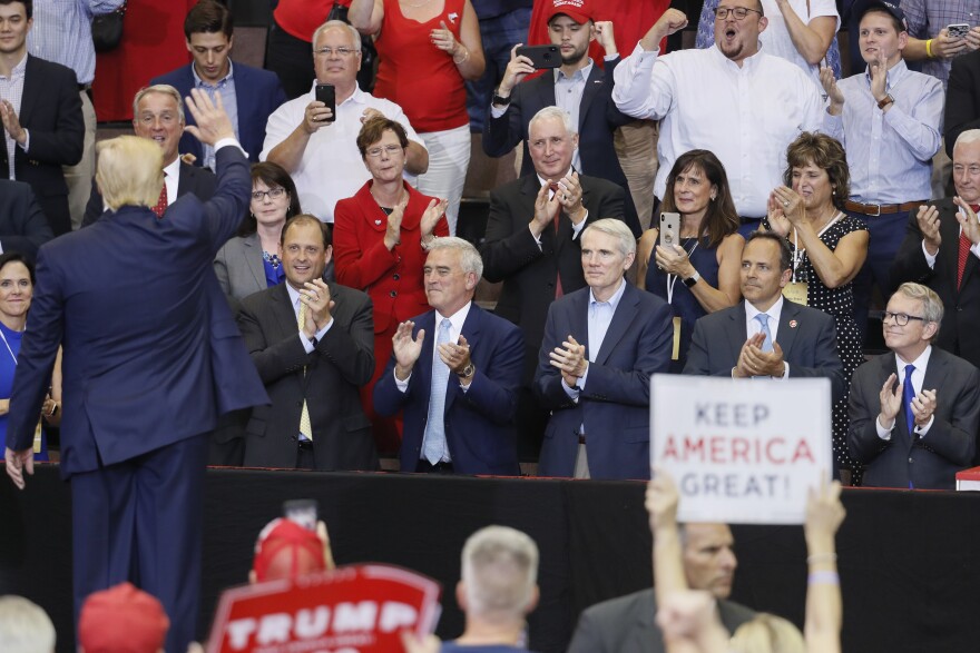 President Trump waves to a crowd featuring from right, Ohio Gov. Mike DeWine, then-Kentucky Gov. Matt Bevin, Sen. Rob Portman, R-Ohio, and Rep. Brad Wenstrup, R-Ohio, at a campaign rally at U.S. Bank Arena, Thursday, Aug. 1, 2019, in Cincinnati.