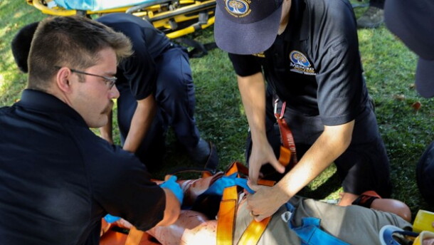 Cameron Loureiro, left, puts spider straps on a dummy patient who has lost limbs during an emergency call scenario.