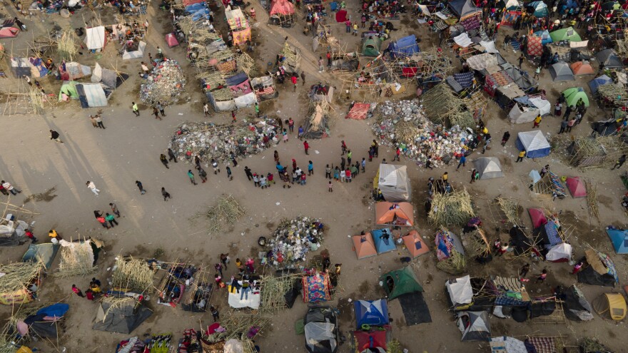 Migrants, many from Haiti, are seen at an encampment along the Del Rio International Bridge near the Rio Grande River on Tuesday.