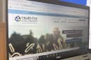 An image of a healthcare website is shown on a computer base.