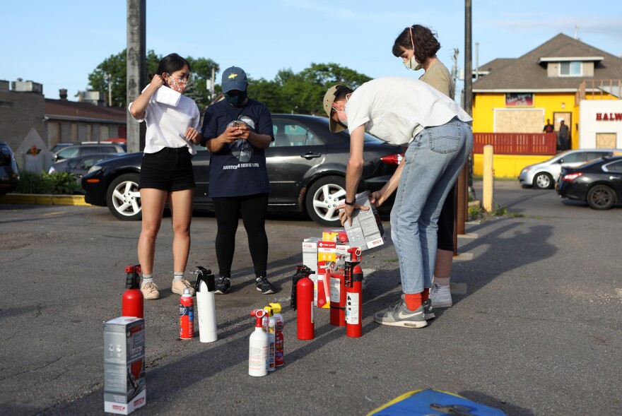 Residents are given fire extinguishers in case protesters set businesses ablaze as they have in Minneapolis and across the nation.