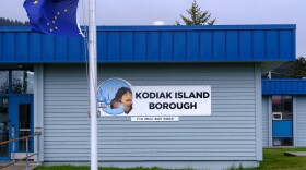 The Kodiak Island Borough building features a state flag near the entrance. (Brian Venua/KMXT)