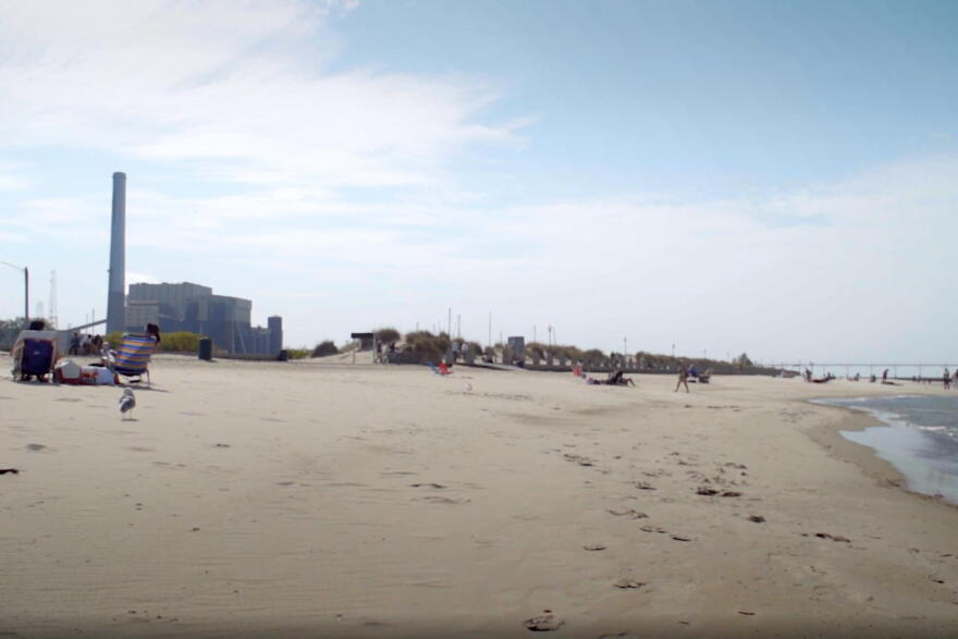 Kids play at the beach at Washington Park not too far from the NIPSCO coal plant.