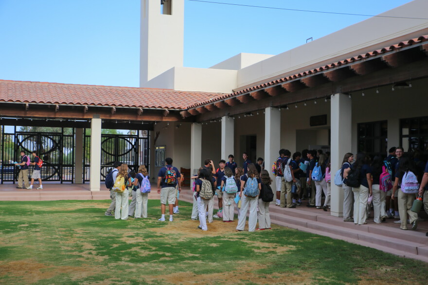Students mill around the courtyard at Yuma Catholic High School on the first day of school.