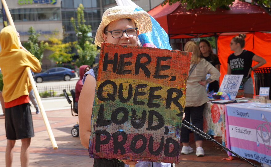 Rally supporters holding signs.