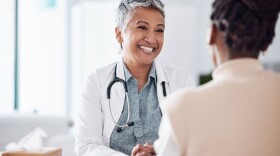 Happy, mature or doctor consulting a patient in meeting in hospital for healthcare help, feedback or support. People, medical or nurse with black woman talking or speaking of test results or advice.