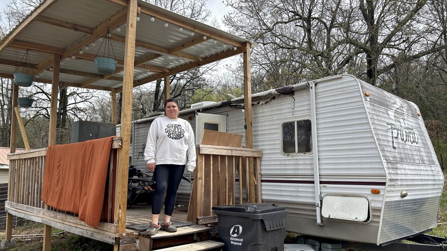 Gabbie Price stands next to her camper home in Moody, Alabama, on March 15, 2024. 