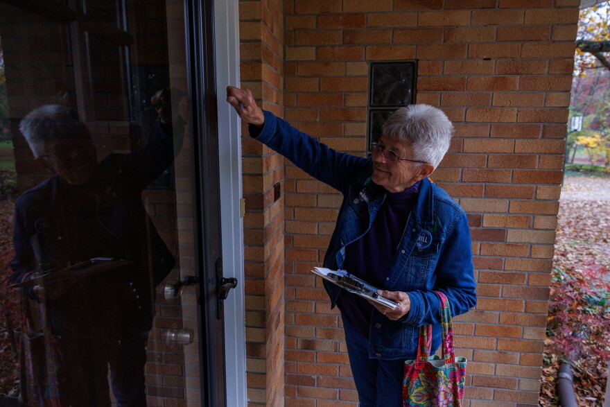 Melany Mack knocks doors for Democratic U.S. House nominee William Lawrence in Okemos, Mich., on Oct. 29, 2026.