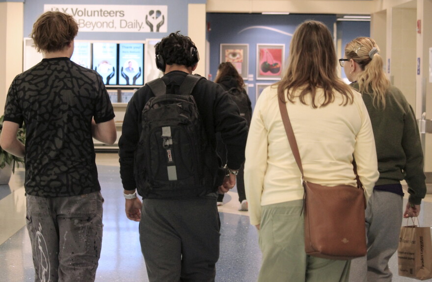 Close family friends welcome Sebastian Jimenez Peroza and Antmary Peroza Barrios at Jacksonville's airport terminal Sept. 5. (María Sofía Rodríguez/WUFT News)