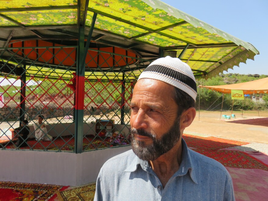 Raja Nafees Ahmed at the grave of his son-in-law, Mumtaz Qadri, near the Pakistan capital of Islamabad. Qadri was a policeman in 2011 when he shot and killed a politician who questioned the country's blasphemy laws. Qadri was hanged last month and his grave has become a shrine for supporters who insist that blasphemy laws not be eased.