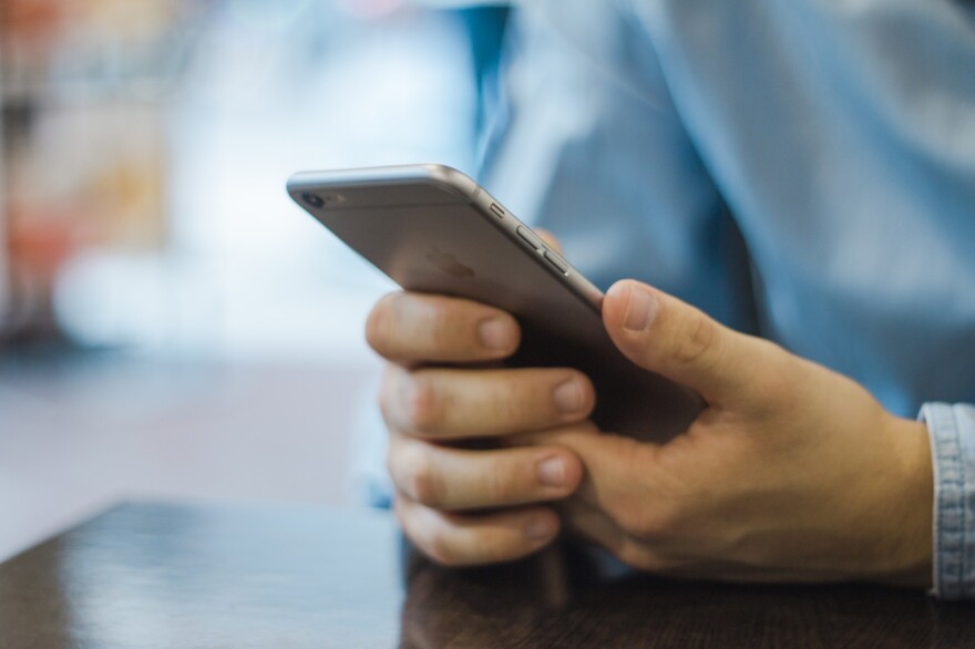 a person holds a cell phone