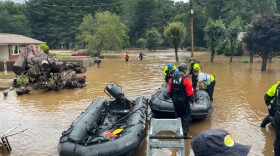 Two people have died and about 20 people remain missing in Haywood County on Thursday in floods caused by Tropical Storm Fred. In this image provided by New Hanover County Fire Rescue, members of North Carolina’s Task Force 11, based in New Hanover County, are shown during rescue efforts in Canton, N.C, on Tuesday, Aug. 17, 2021. 