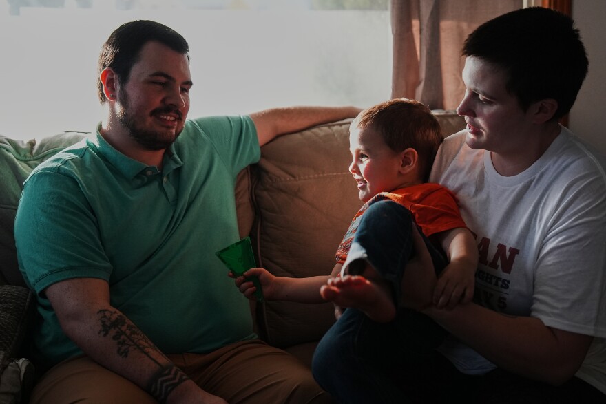 Morgan Carroll, right, relaxes at home with her son, River, center, and husband, Hunter, left, Tuesday, March 10, 2026, in Shelby, Ohio.
