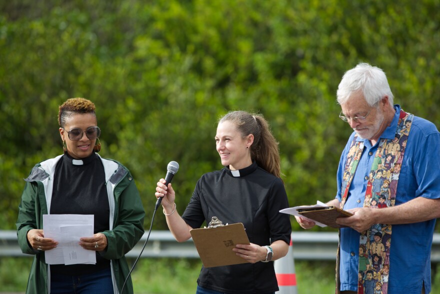 Clergy members speak to a crowd near Alligator Alcatraz