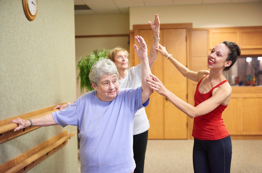 Vanessa Woods, right, founder of Vitality in Motion, assists adult students in one of her bi-weekly ballet classes.<br/>