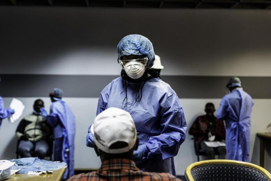 A medical worker tests Haitians for coronavirus in Port-au-Prince.