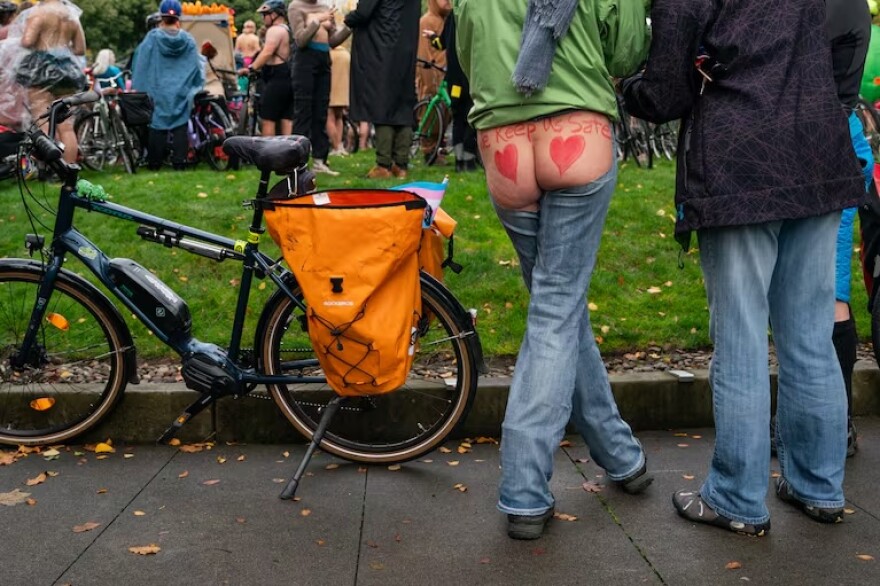 People get ready for a naked bike ride on Sunday, Oct. 12, 2025 in Portland, Ore.