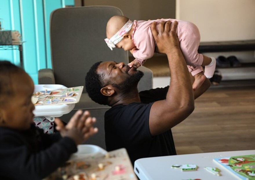Richard Morris of Morris Munchkins Playhouse in Chili cares for six month old Noemi Andrews. He and his wife, India Morris, own the home-based daycare.