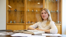 A portrait of Natalie Zenk sitting at a table conducting research.
