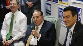 Former Kansas Sen. Bob Dole (center) takes questions during a visit to the Johnson County Republican headquarters in Overland Park, Kan., on Monday. With him are Gov. Sam Brownback (left) and Rep. Kevin Yoder.