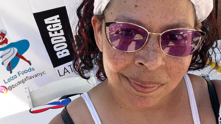 Latin woman with freckles wearing a headband and looking into the camera