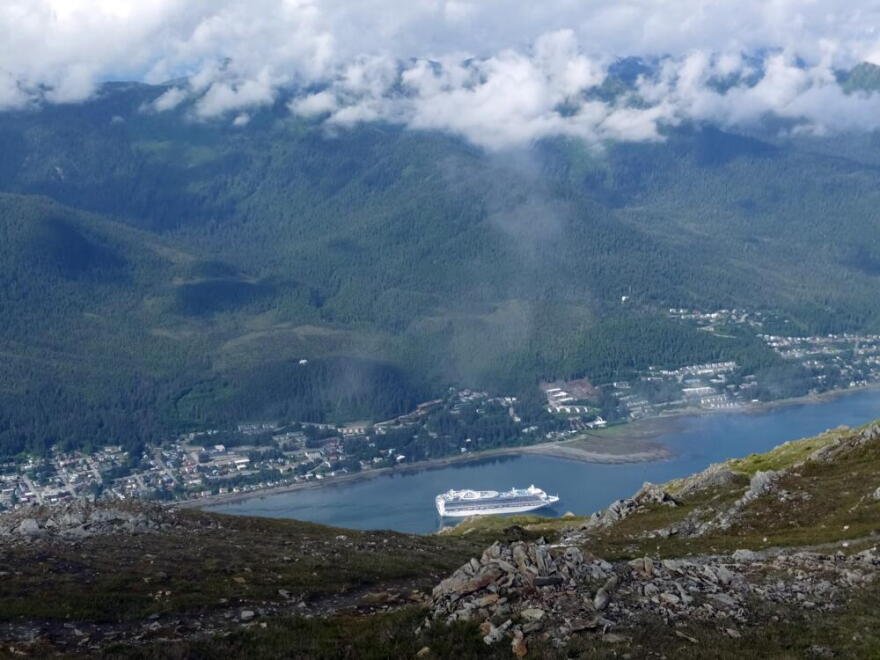 A cruise ship approaches its stop in downtown Juneau, Alaska, as glimpsed from along the Mount Roberts trail. (Becky Bohrer/AP)