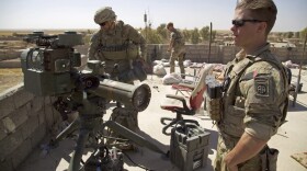 In this Aug. 20, 2017 file photo, U.S. Army soldiers stands next to a guided-missile launcher, a few miles from the frontline, in the village of Abu Ghaddur, east of Tal Afar, Iraq. American troops have started to draw down from Iraq following Baghdad’s declaration of victory over the Islamic State group last year, according to western contractors at a U.S.-led coalition base in Iraq. (Balint Szlanko/AP)