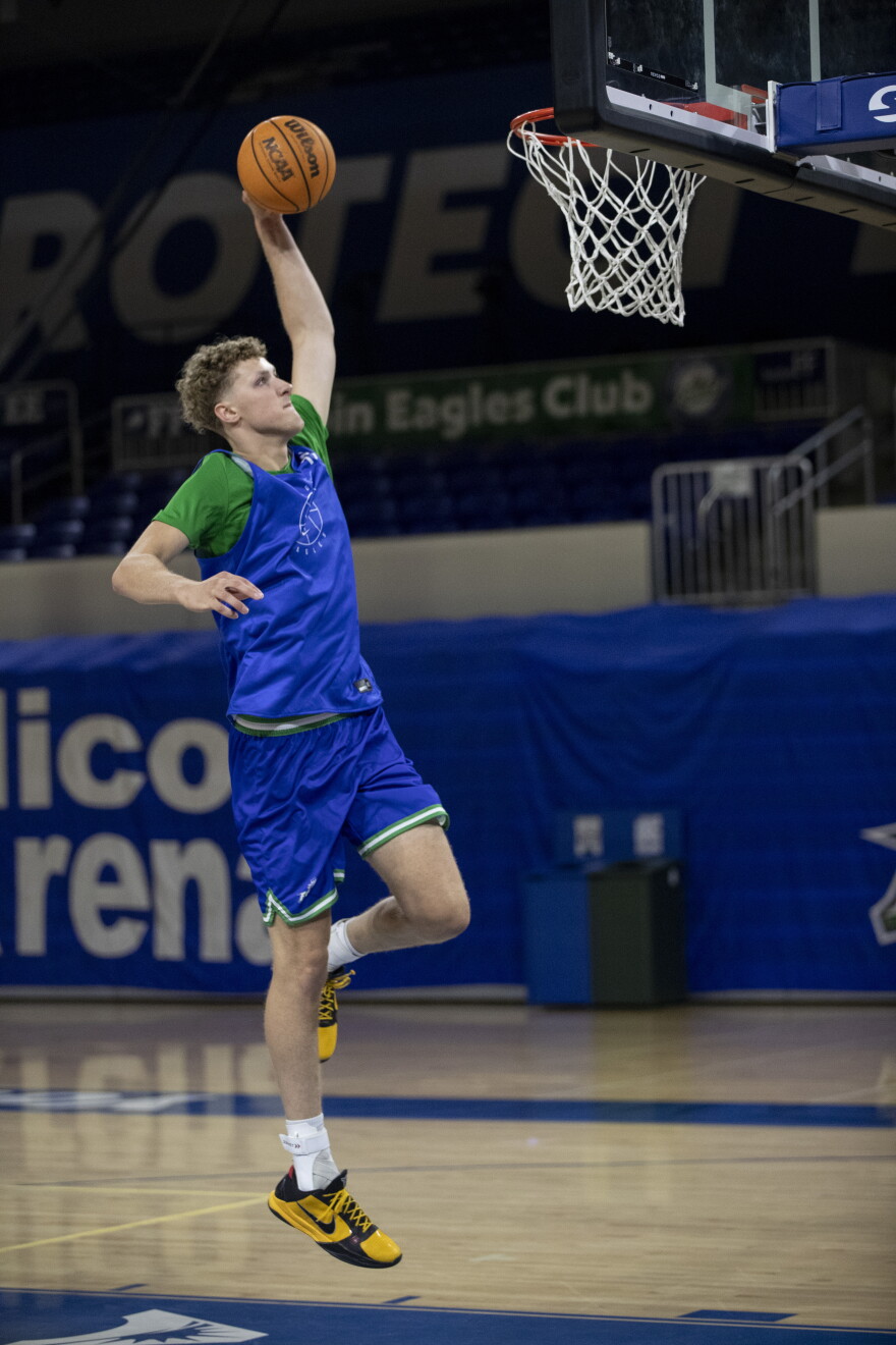 Seven-footer Justin Houser dunks during practice on Monday, Sept. 21, 2026, at FGCU’s Alico Arena.
