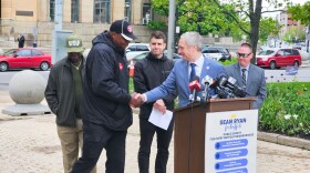 Buffalo mayoral candidate and State Senator Sean Ryan, second from right shakes hands with Stop the Violence Coalition Murray Holman during a press conference detailing Ryan's public safety plan if elected mayor. 