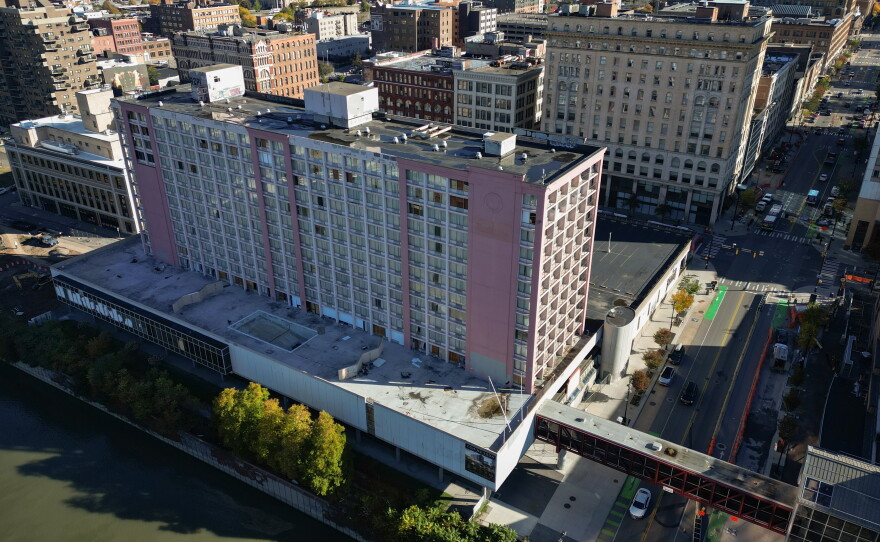 The former Rochester Riverside Hotel at 120 E. Main St. in downtown Rochester, N.Y., connects to the convention center via an elevated walkway over the street. The hotel property has been vacant since closing in early 2020, and seen extensive vandalism as it awaits a proposed $61 million redevelopment by local developer Angelo Ingrassia and Ellicott Development that would convert the property into a mixed-use complex with hotel rooms, apartments, retail and restaurant space.