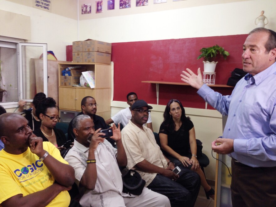 Rabbi Yechiel Eckstein, founder of the International Fellowship of Christians and Jews, welcomes Church of God in Christ leaders to a migrant assistance center in Tel Aviv.