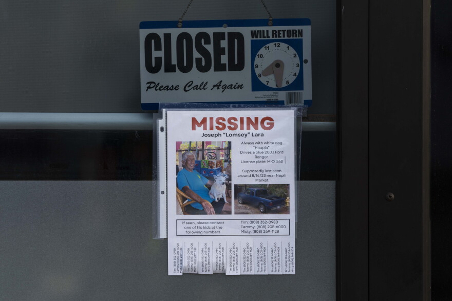 A missing person flyer for Joseph "Lomsey" Lara is posted on the door of a business in a shopping mall in Lāhainā, Hawaiʻi, Monday, Aug. 21, 2023.