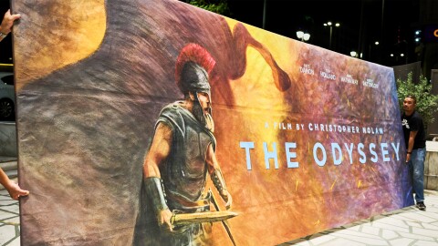 Workers install a hand-painted billboard, painted by artist Virginia Axioti, for Christopher Nolan's upcoming film "The Odyssey," starring Matt Damon as Odysseus, outside Athens' Athinaion cinema, Saturday, July 11, 2026.