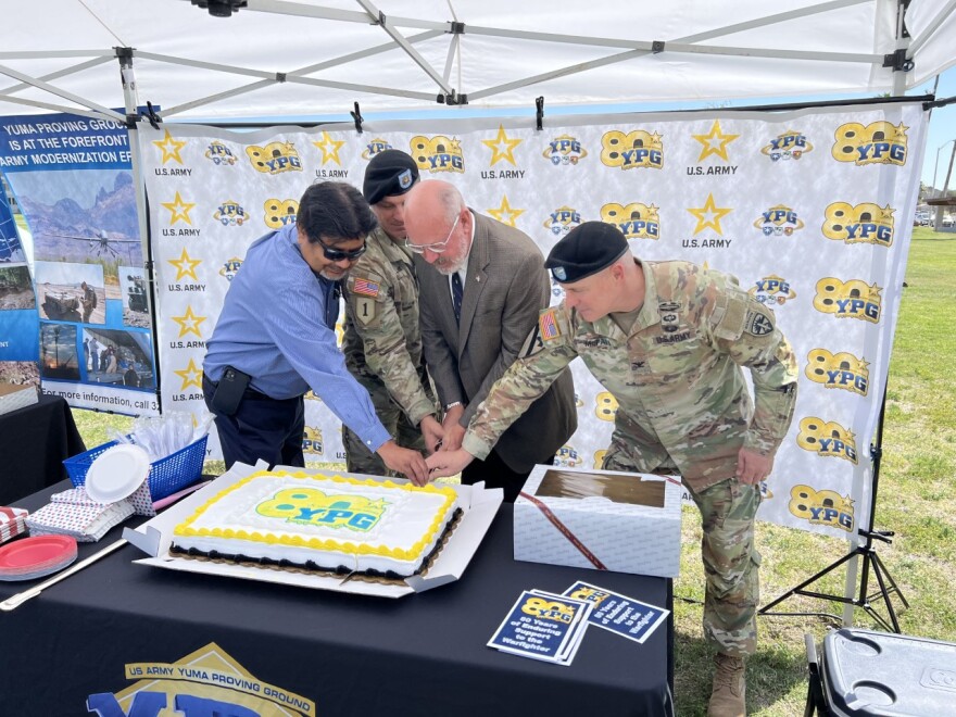 Yuma Proving Ground officials cut a birthday cake to celebrate YPG's 80th birthday on Wednesday, May 3, 2023. Left to right: Larry Bracamonte, Technical Director of YPG; Command Sgt. Maj. Herbert Gill, Col. (Ret.) Robert Filbey and Commander Col. Patrick McFall.