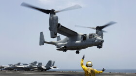 FILE - In this image provided by the U.S. Navy, Aviation Boatswain's Mate 2nd Class Nicholas Hawkins signals an MV-22 Osprey to land on the flight deck of the USS Abraham Lincoln in the Arabian Sea on May 17, 2019. Three Massachusetts lawmakers are pressing Defense Secretary Lloyd Austin to extend flight restrictions on the V-22 Osprey until the military can identify the root causes of multiple recent accidents. Democratic Sens. Elizabeth Warren and Ed Markey and Rep. Lloyd Neal in a letter to Austin on Thursday call the decision to return Ospreys to limited flight status misguided. (Mass Communication Specialist 3rd Class Amber Smalley/U.S. Navy via AP)