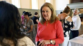 Linda Autore, president and CEO of Laurel House, offering housing assistance to people experiencing mental illness, speaks to an attendee after a mental health panel held with several nonprofit organizations at Christ & Holy Trinity Church in Westport, Connecticut June 21, 2024.