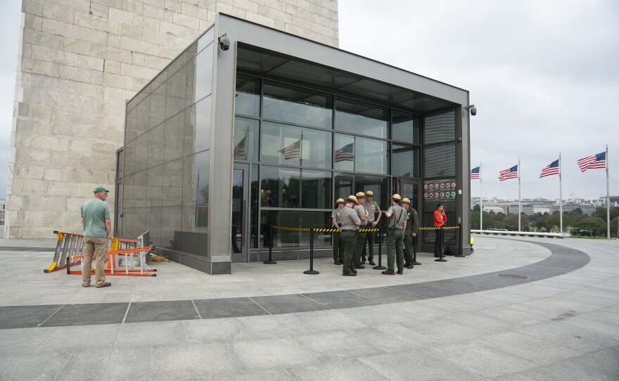 National Park Service rangers stand outside the newly constructed screening facility.