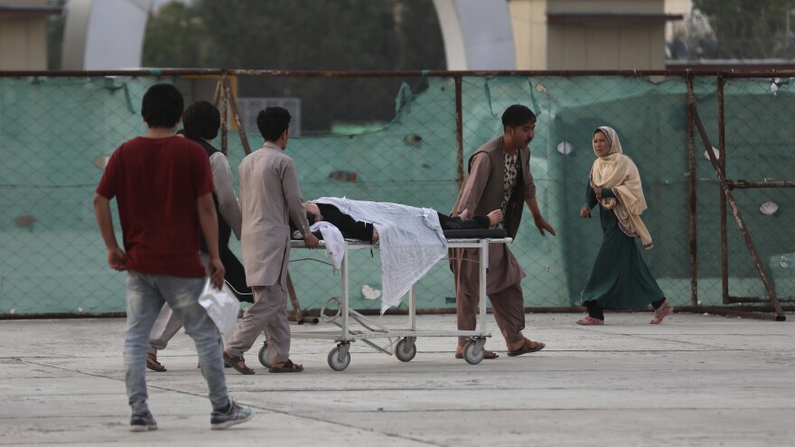 An injured school student is transported to a hospital after a bomb explosion near a school in Kabul, Afghanistan, on Saturday.