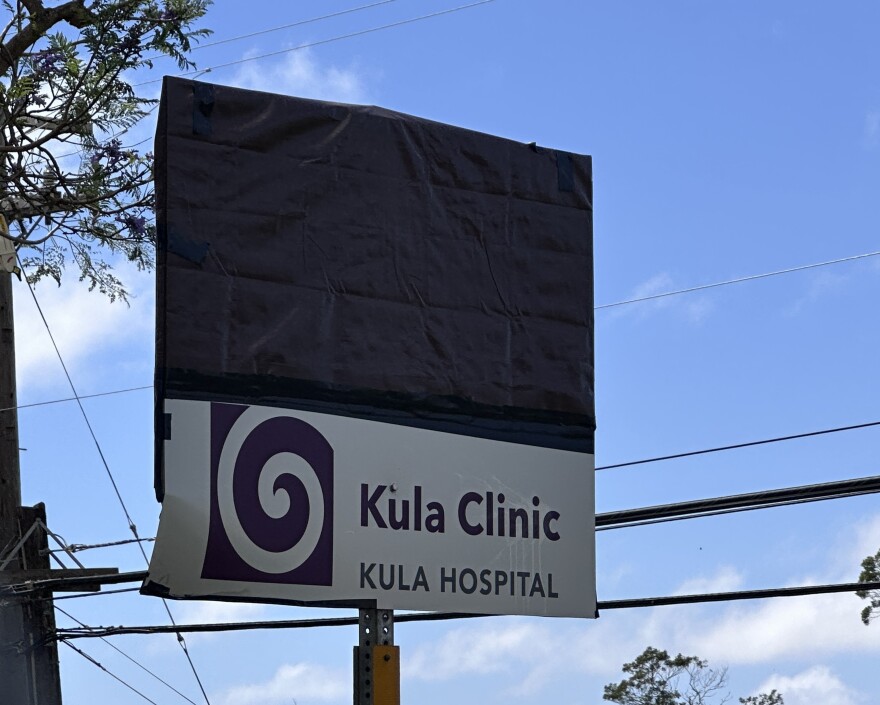 A Kula Hospital sign is covered with a tarp, while the facility's small Kula Clinic remains open.