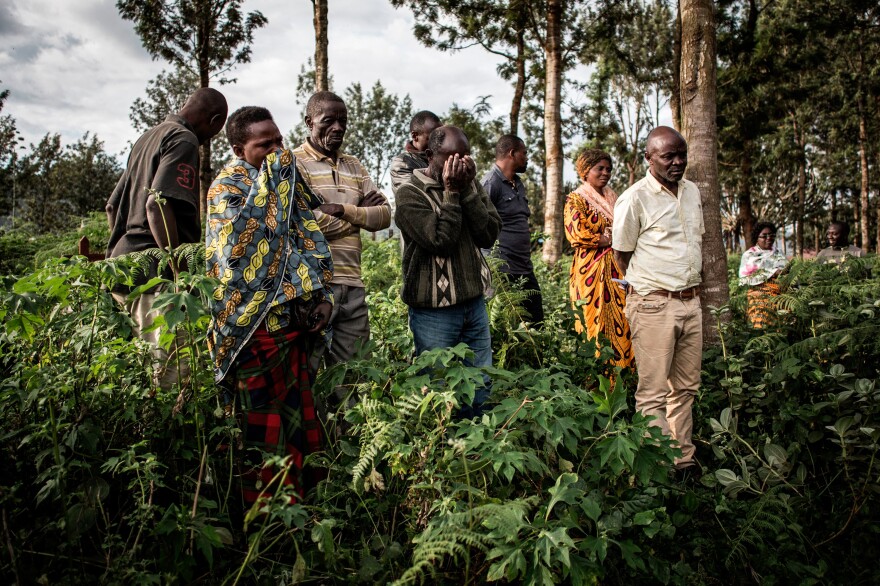 Family members watch the burial.