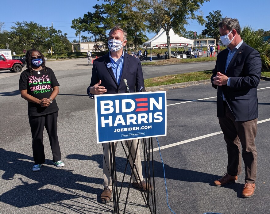 (l. to r.) Tallahassee Mayor Pro-tem Dianne Williams-Cox, Leon County Commissioner Rick Minor and Tallahassee Mayor John Dailey make their get-out-the-vote pitch with the supervisor of elections mail ballot drop-off facility in the background.