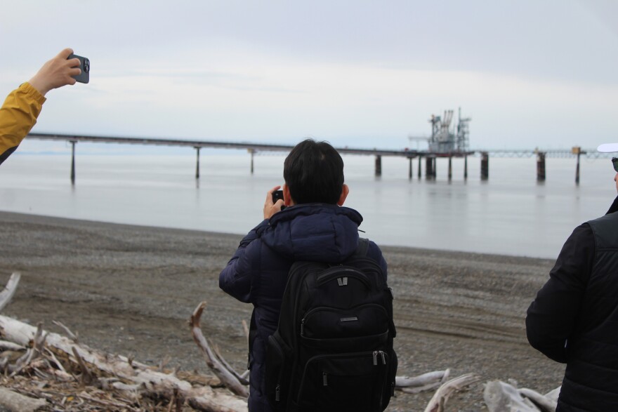 People take pictures of the former Kenai LNG export terminal during an Alaska LNG Project event on Monday, May 18, 2026 in Nikiski, Alaska.