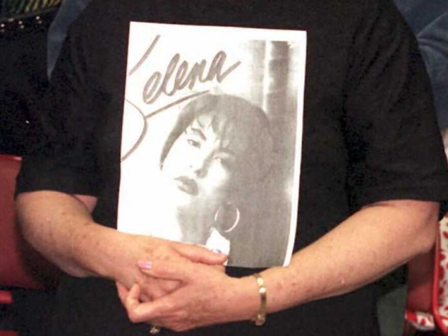 Detail of a photo of Selena fan Olivia Leak, shown holding a poster of the pop star at a memorial held in Los Angeles on April 2, 1995, two days after Selena's murder in Corpus Christi, Texas.