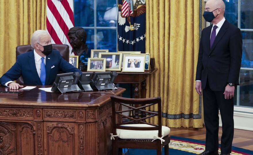 President Biden talks with Secretary of Homeland Security Alejandro Mayorkas before signing several executive orders on immigration on Feb. 2.
