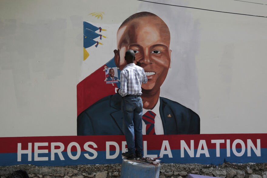FILE - Artists paint a portrait of slain Haitian President Jovenel Moise near the presidencial residence where he was assassinated two years ago in the Petion-ville area of Port-au-Prince, Haiti, July 7, 2023.