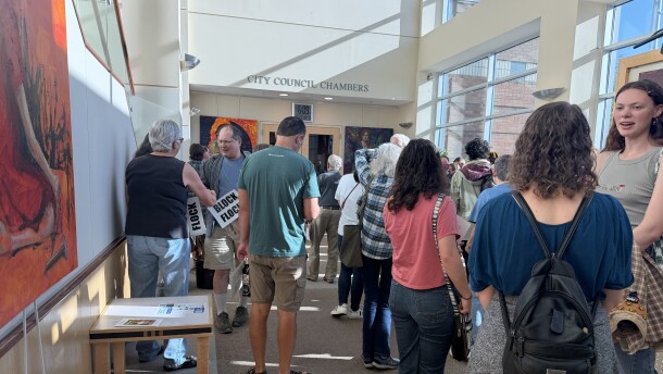 Residents gather outside of Albany City Counsel Chambers holding "Block Flock" signs before the meeting, May 27, 2026.