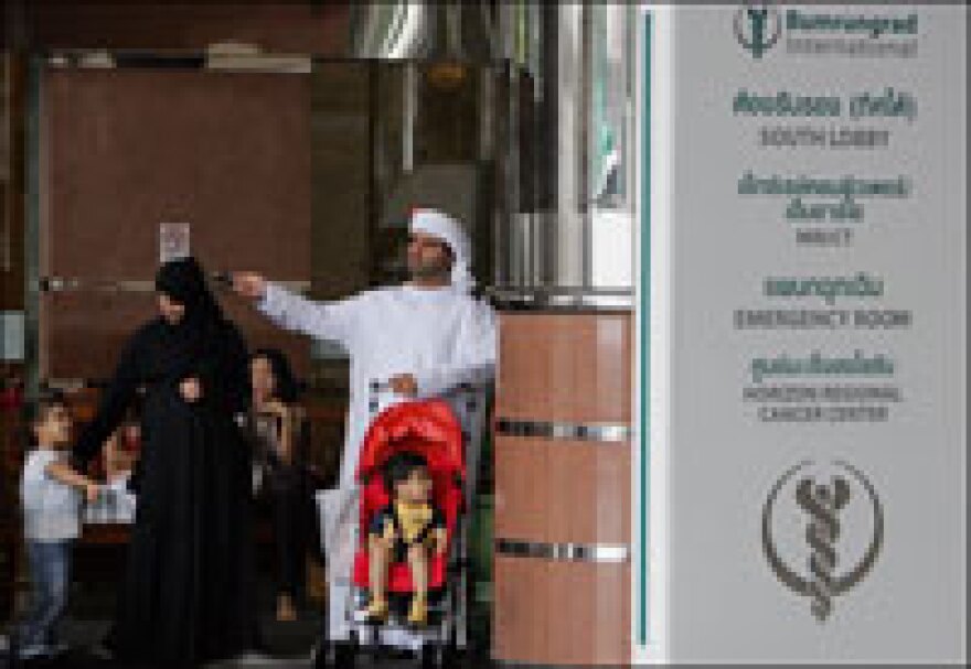 An Arab family waits outside Bumrungrad International Hospital in Bangkok, which attracts patients from across the world, in 2005.