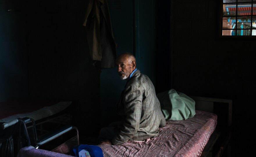 A resident of the senior home in his room after lunch.