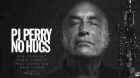 PJ Perry holds his saxophone in hand with his eyes closed. 